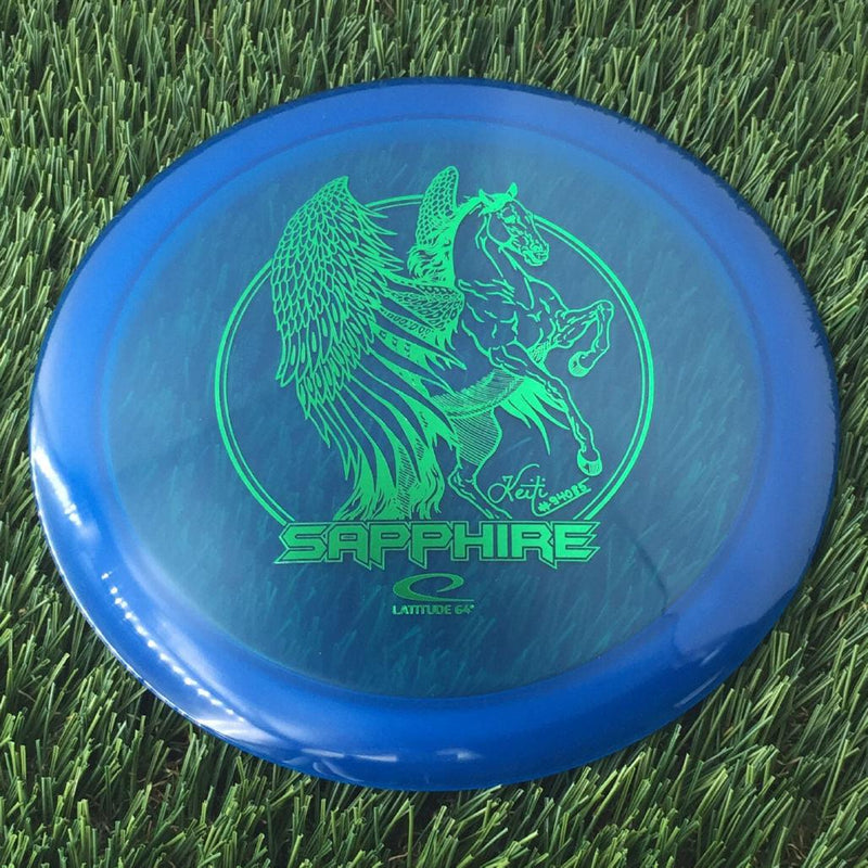 Latitude 64 Opto Sapphire with Keiti Tatte Team Series 2023 Stamp - 164g - Translucent Blue