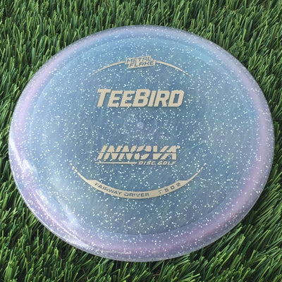 Innova Champion Metal Flake Teebird with Burst Logo Stock Stamp - 149g - Translucent Bluish Clear