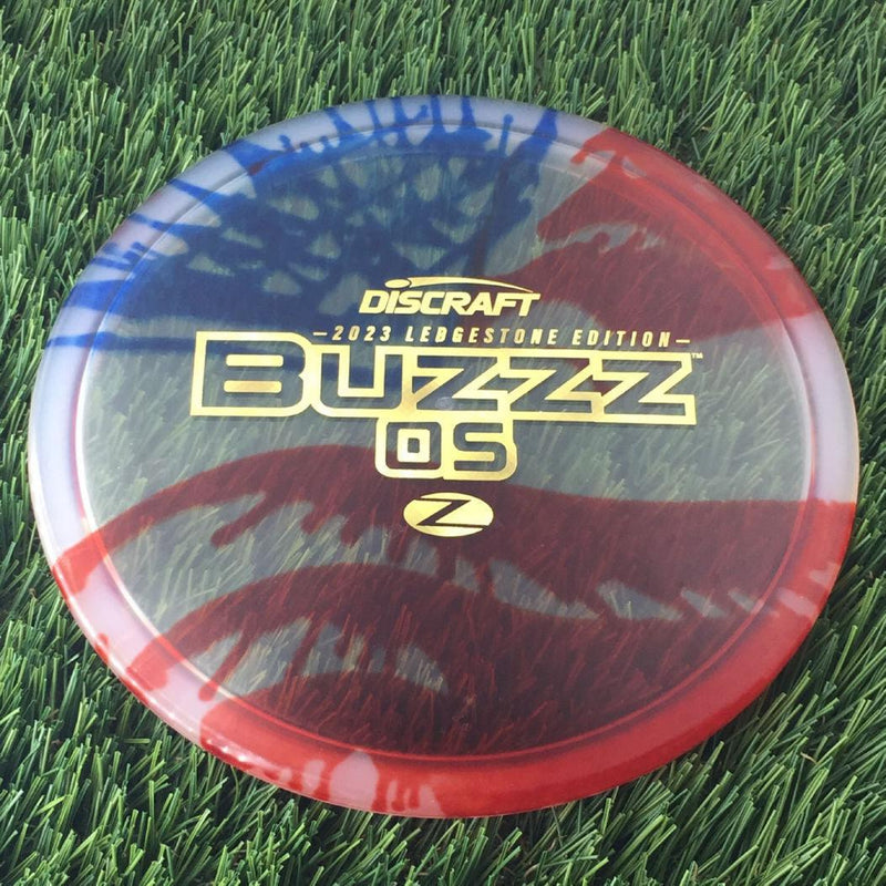 Discraft Elite Z Fly-Dyed BuzzzOS with 2023 Ledgestone Edition - Wave 2 Stamp - 180g - Translucent Flag