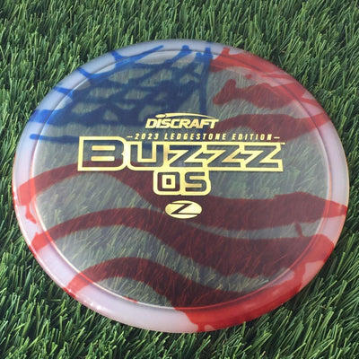 Discraft Elite Z Fly-Dyed BuzzzOS with 2023 Ledgestone Edition - Wave 2 Stamp - 180g - Translucent Flag